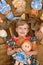 Portrait of little girl(child, kid) with dolls on the carpet