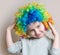 Portrait of little girl in colourful wig