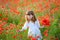 Portrait of little girl gathers a bouquet of flowers for mother