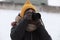 Portrait of a little girl and holding camera in park. little girl photographer in winter. young photographer. girl with a camera