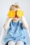 Portrait of Little Girl Holding Halves of Orange Near Eyes