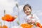 Portrait of a little girl on poppy flowers field in front of cloudy sky