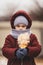 Portrait of a little girl with a sad look and a toy in her hands. The social problem of refugees and internally displaced persons