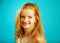 Portrait of little girl seven years old with fiery red hair, cute freckles, smiling sincerely, expresses confidence and