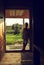 portrait of Little girl stands near the door at sunset