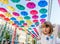 Portrait little girl in the Street decorated with colored umbrellas