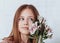 Portrait of a little girl in the studio. A girl stand  and holds a bouquet of flowers in her hands