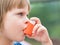 Portrait of little girl using asthma inhaler outdoors