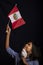 Portrait of little girl wearing medical mask and holding hopefully the flag of Peru