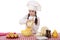 Portrait of a little girl in a white apron and chefs hat shred c
