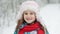 Portrait little girl in winter pink hat in snow. Cute little girl in warm hat outdoors on cold winter day. Beautiful