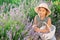 Portrait of little happy girl with basket on field with lavender