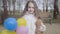 Portrait of little joyful kid posing in sunny spring or autumn park. Brunette curly-haired Caucasian girl holding teddy