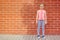 Portrait of little kid girl laughing at bricks wall background