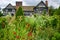 Portrait of Little Moreton Hall and flowers