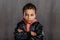 Portrait of little multiracial boy with leather jacket.