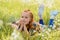 portrait of little pensive child resting on green grass