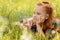 portrait of little pensive child resting on green grass