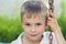 Portrait of a little smiling boy with golden blonde straw hair i