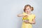 Portrait of little smiling girl with a shopping basket filled with Easter things