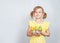 Portrait of little smiling girl with a shopping basket filled with Easter things