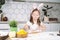 Portrait of little smiling studiously girl, cooking, prepare dough, rolling pin with flour. Making easter bakery cookies