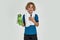 Portrait of little sportive boy child in sportswear smiling at camera, holding water bottle while standing with towel