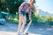 Portrait of a little teenage girl, holding in hand skateboard, trains to do the trick