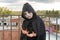 Portrait of a little teenager girl in a zombie costume against the background of an old and destroyed building. Halloween and day