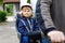 Portrait of little toddler girl with security helmet on the head sitting in bike seat and her father with bicycle. Safe