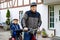 Portrait of little toddler girl with security helmet on the head sitting in bike seat and her father with bicycle. Safe