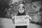 Portrait little upset child calls No War, raises banner with inscription Stop war in Ukraine. Peace, stop russian aggression.