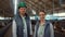 Portrait livestock team posing together modern cowshed at dairy farm facility