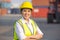 Portrait of logistic engineer worker woman foreman in hardhat and safety at containers cargo