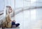 Portrait of lonely little girl in yellow dress sitting on floor