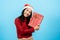 portrait, Long-haired Asian girl in red long-sleeved top wearing christmas hats, took the thrown gift box,
