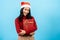 portrait, Long-haired Asian girl in red long-sleeved top wearing christmas hats, took the thrown gift box, and hugged it, her