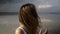 Portrait of a long haired woman standing in front the lake with mirror reflection sky