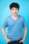 Portrait of look good asian kid boy on blue background