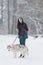 Portrait of Lovely Caucasian Brunette Woman Along With Her Husky Dog.