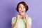 Portrait of lovely cheerful amazed brown-haired girl celebrating great luck isolated over violet color background