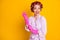 Portrait of lovely cheerful cheery housekeeper wearing curlers putting rubber gloves on isolated bright yellow color