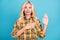 Portrait of lovely confident honest wavy-haired woman giving promise isolated over bright blue color background