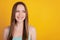 Portrait of lovely curious cheerful young lady white smile look side empty space on yellow background