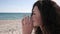 Portrait lovely girl with curly hair, drinks cocktail straw, Ñoconut, summer season, on background sea ocean and sand