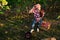 Portrait of a lovely girl in a red shirt in the garden beautiful girl holds apples near the face and stands near the