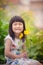 Portrait of lovely girl with yellow cosmos flower bouquet in han