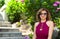 Portrait of a lovely middle aged woman wearing sunglasses relaxing in the garden