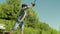 Portrait of lovely Middle Eastern boy casting spin fishing rod on pond