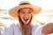 Portrait of lovely pleased blonde woman 20s in summer straw hat